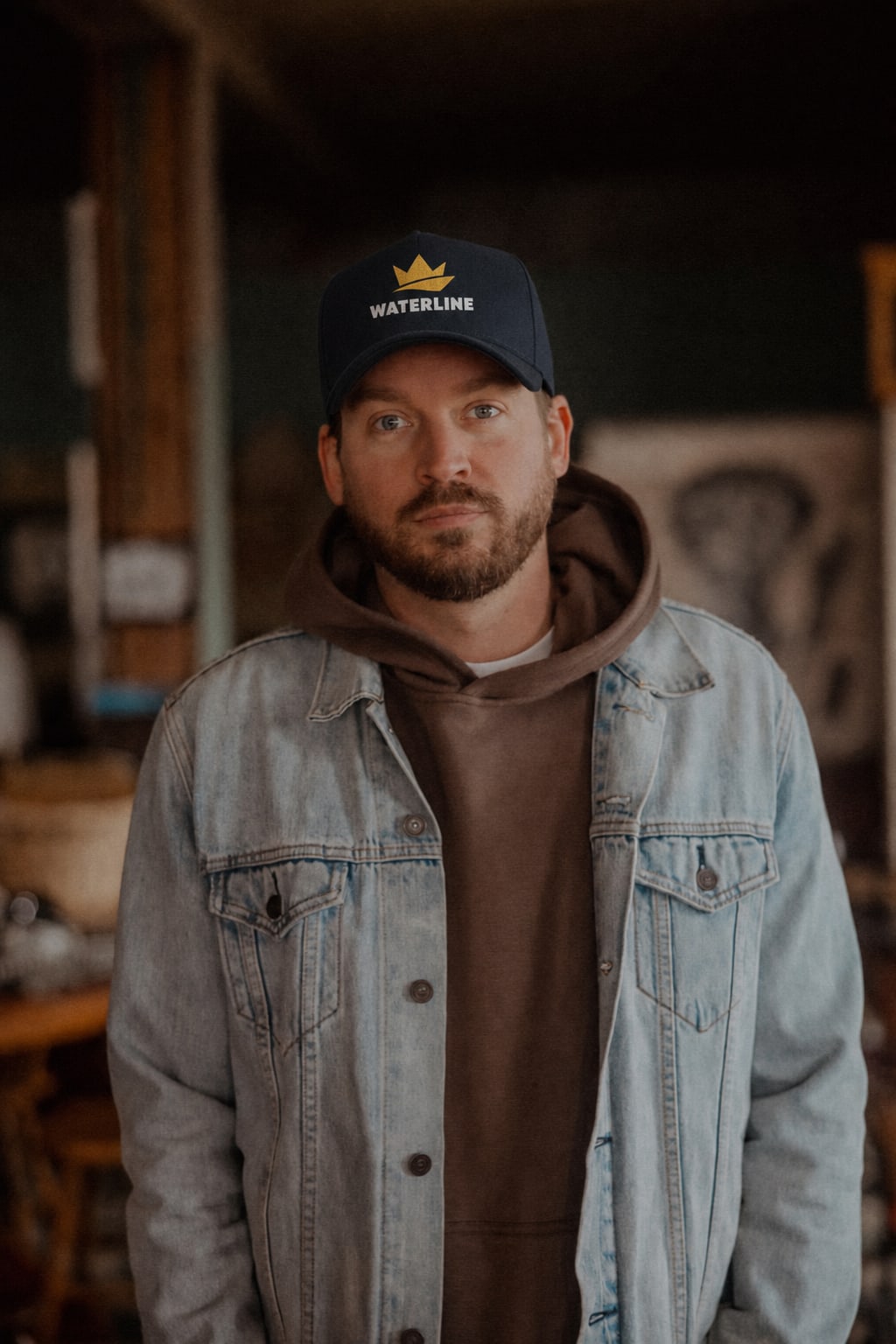 Conor Patton, owner of Waterline Marine Cosmetics, wearing a denim jacket and Waterline hat